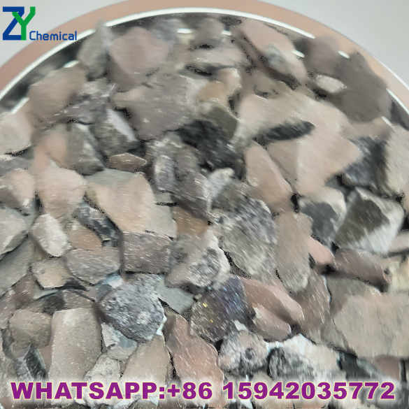 Professional calcium carbide manufacturer loading containers with 100kg iron drums at factory warehouse