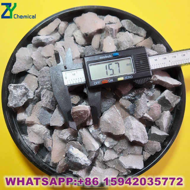 Professional calcium carbide manufacturer loading containers with 100kg iron drums at factory warehouse.